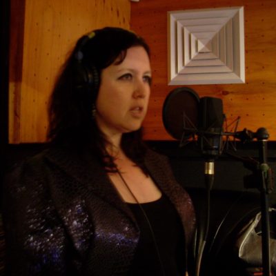 In the singer's booth, concentrating intently during recording of In Lounge-O-Scope